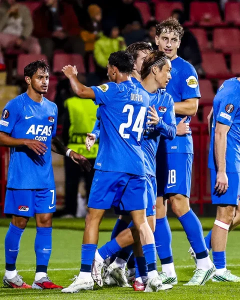 AZ-spelers staan samen op het veld tijdens de wedstrijd.