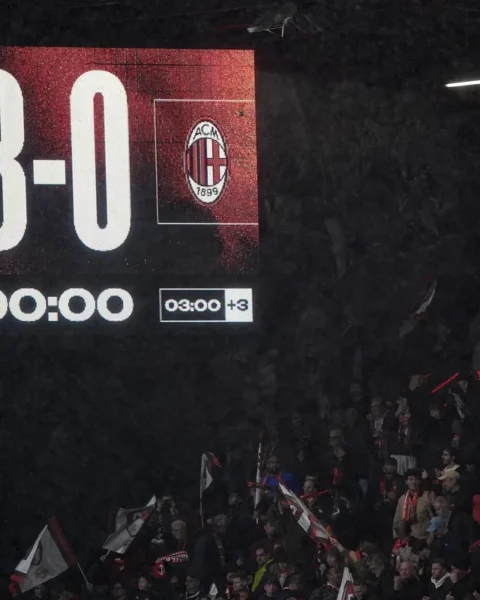 Scoreboard in een stadion toont Bournemouth 3-0 AC Milan, met supporters op de tribunes.