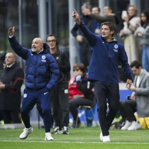 Inter Milan coaches gesture from the touchline during a match.