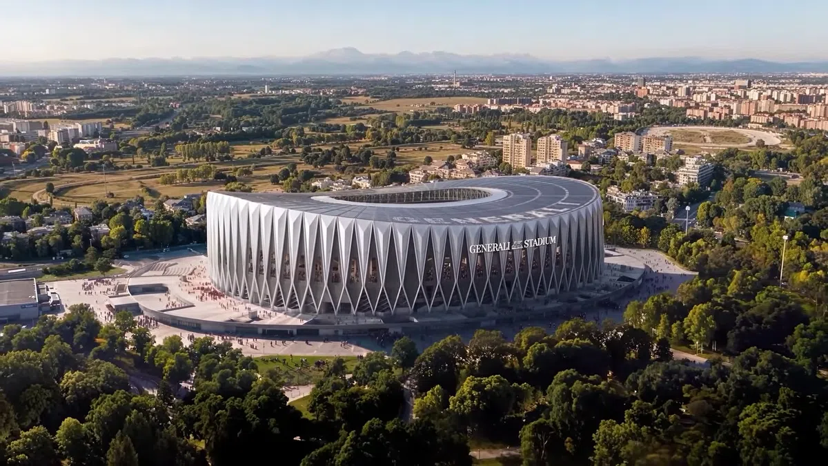 Luchtbeeld van een modern stadionontwerp met de naam Generali Stadium, omringd door groen en bebouwing.