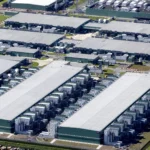 Luchtfoto van een groot datacentercomplex met meerdere serverhallen en technische installaties.