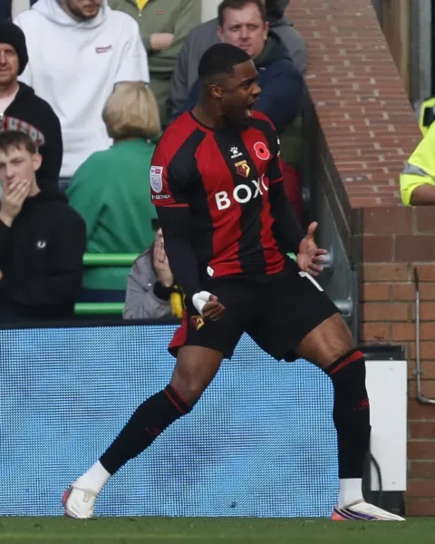 Myron Boadu juicht op het veld in een Watford-shirt tijdens een wedstrijd.