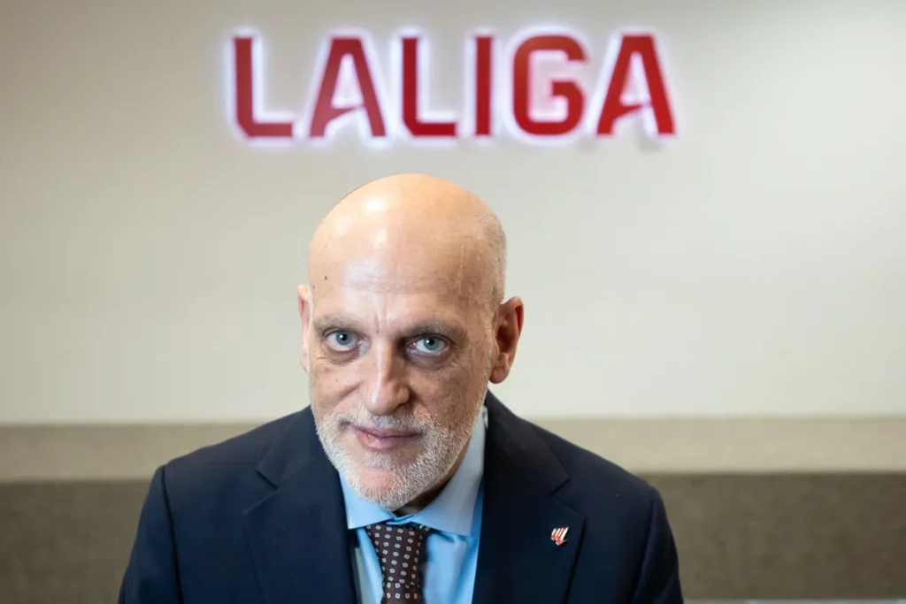 Javier Tebas poses in front of a LaLiga sign.
