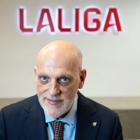 Javier Tebas poses in front of a LaLiga sign.