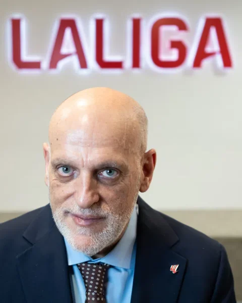 Javier Tebas poses in front of a LaLiga sign.