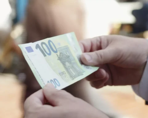 Handen houden een 100-eurobiljet vast.