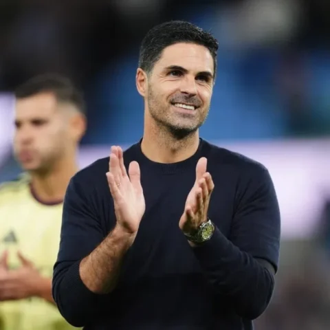 Mikel Arteta applauds on the touchline during a football match.